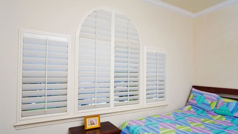 shaped shutters in bedroom