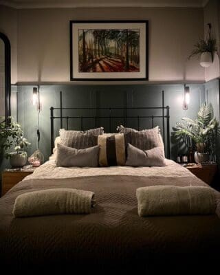 Green wall panels behind bed