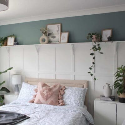 White wall panelling with dark green walls