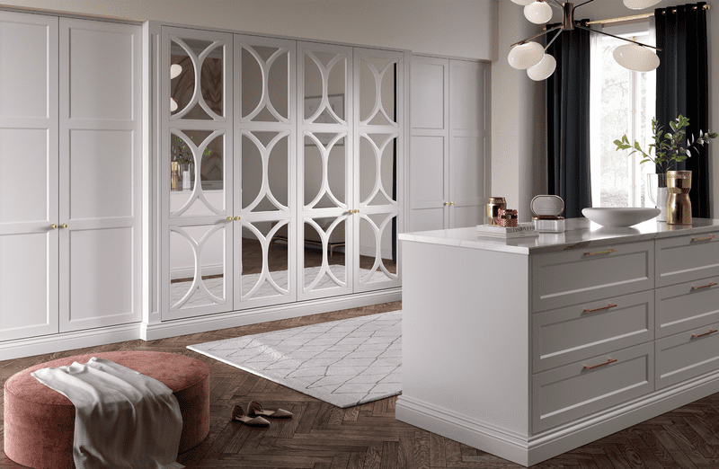 fitted wardrobe with mirror doors and central drawer island