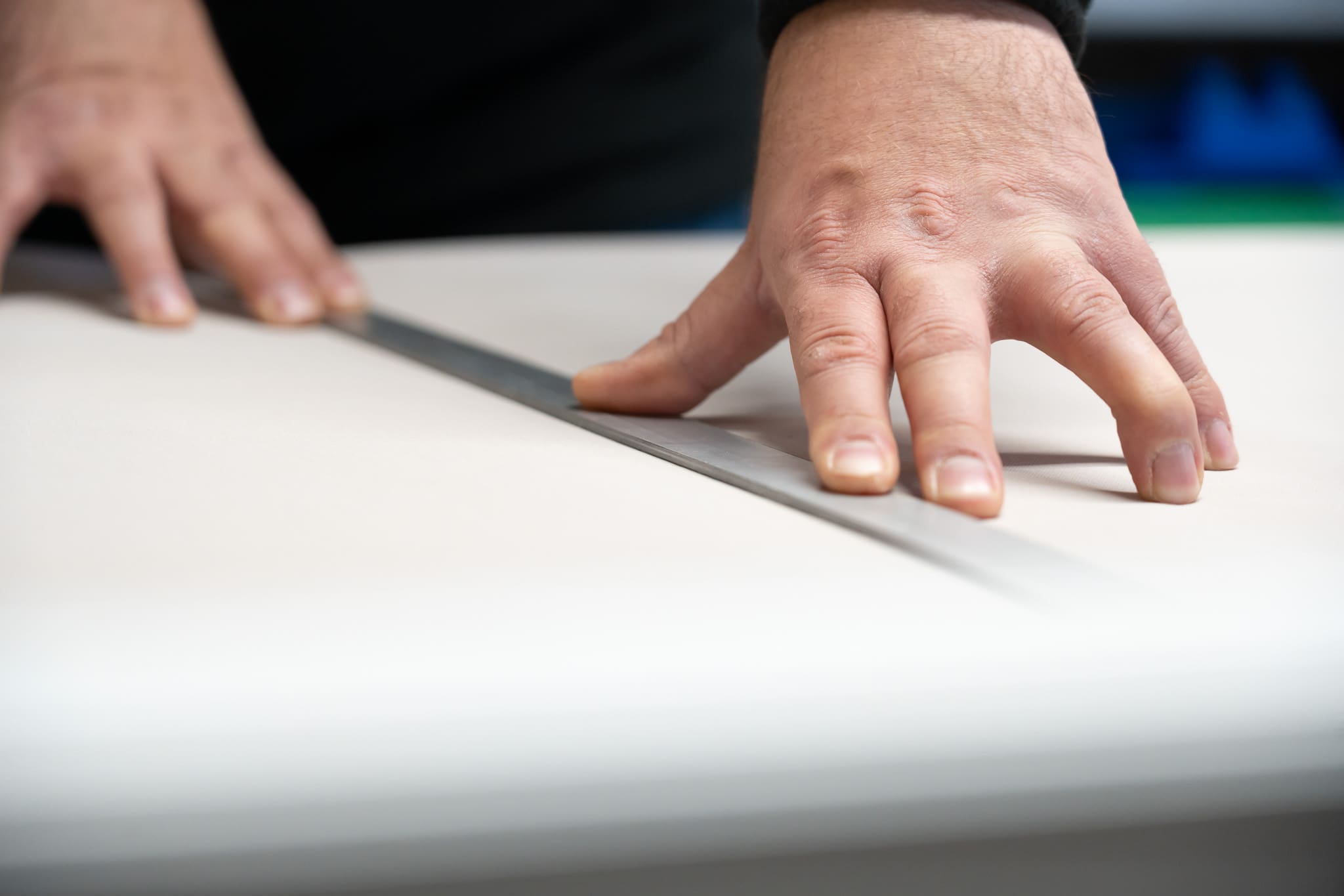 Close up of hands measuring material with a ruler