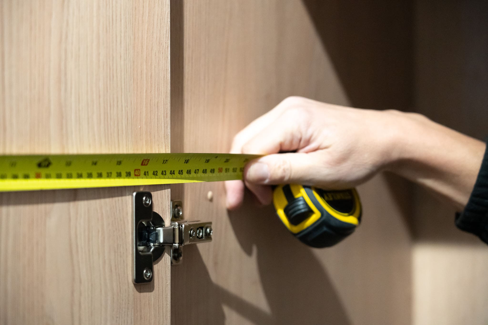 Fitted storage being measured for installation