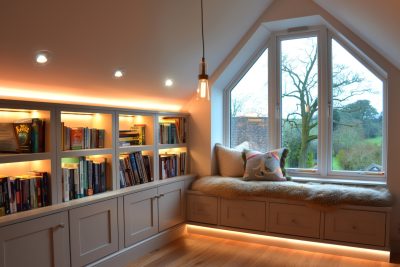 a plush window seat with storage, and soft lighting