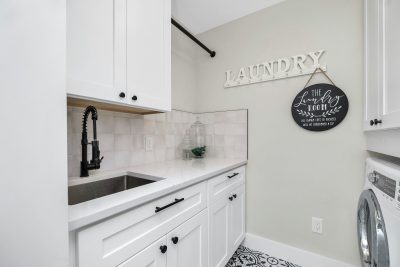 White utility room with fitted storage